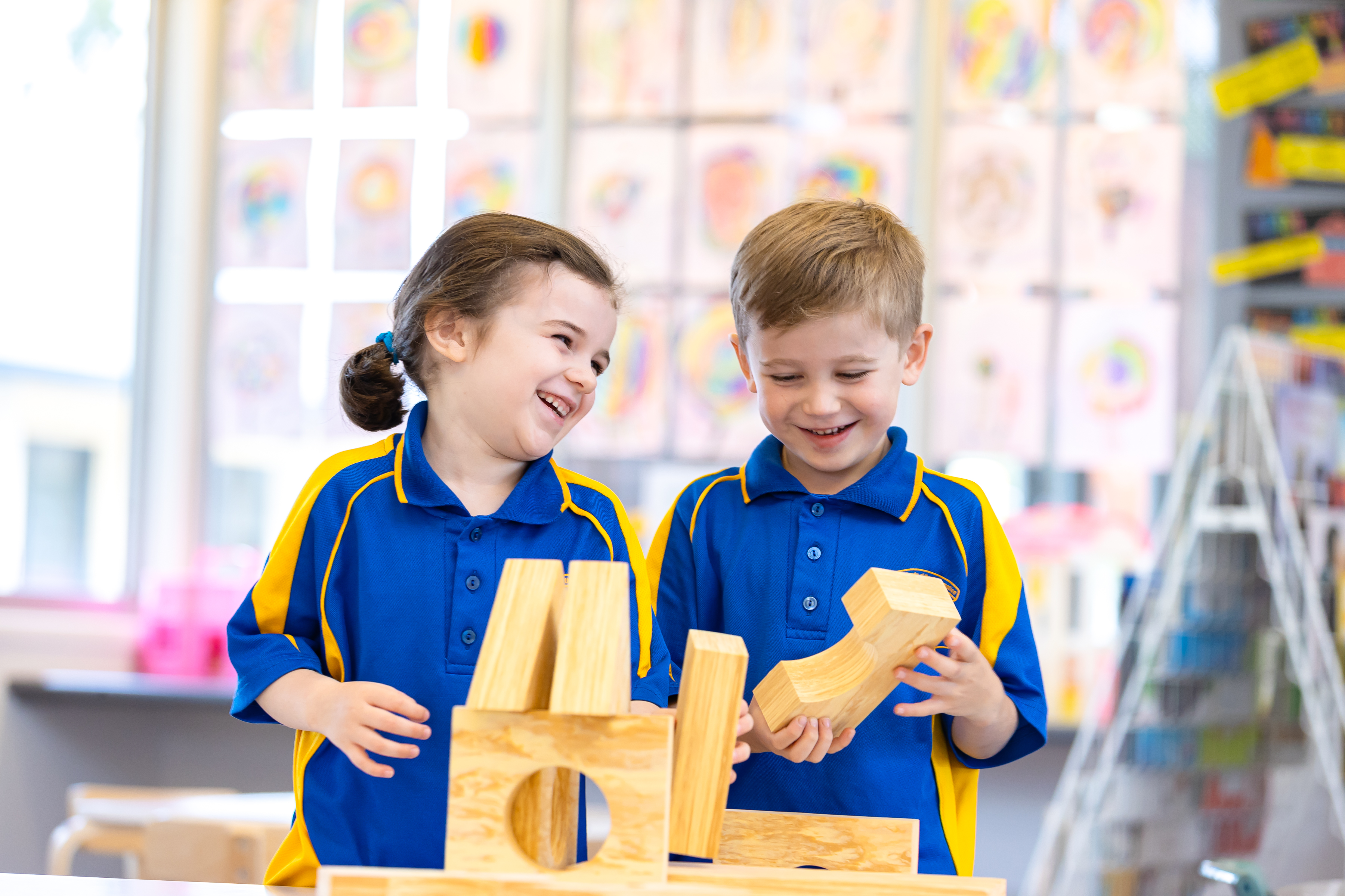 Students working together with wooden blocks during a hands‑on learning activity in a classroom